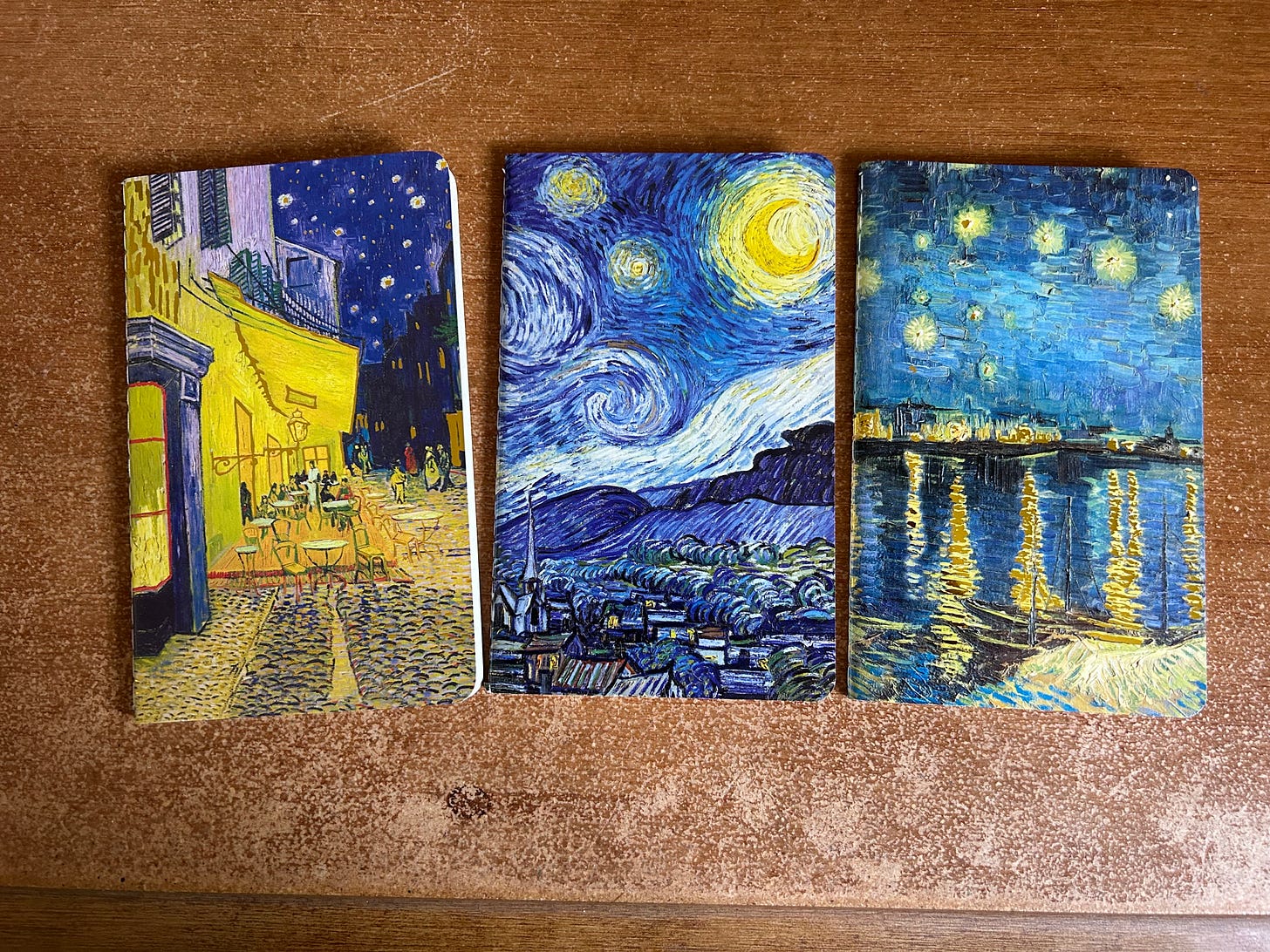 Three passport sized notebooks like on display on a desk. Each one has a Van Gogh painting as a cover. Made by Flame Tree Publishing and purchased from Waterstones Bookshop.Photo: Roland Millward