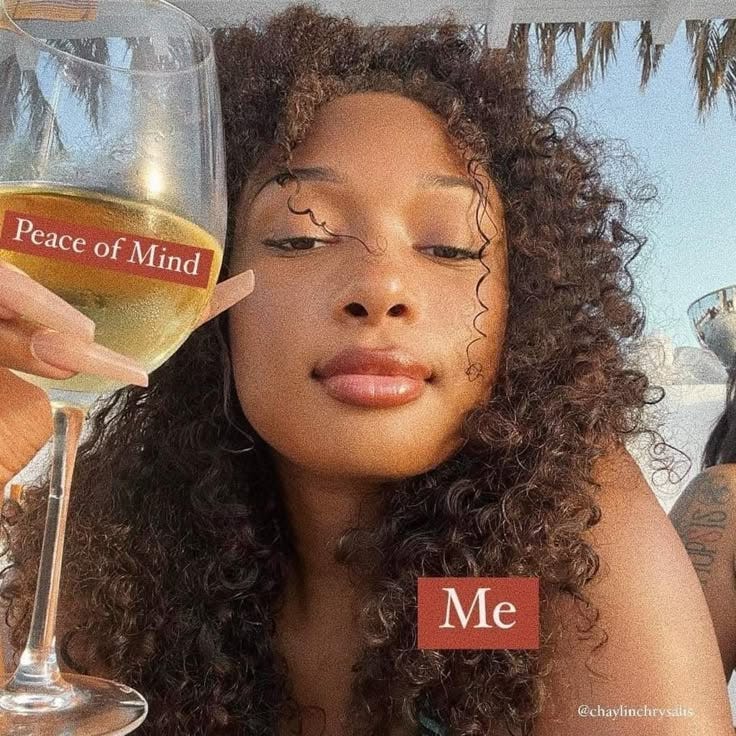 This may contain: a woman holding a wine glass with peace of mind written on the side in front of her face