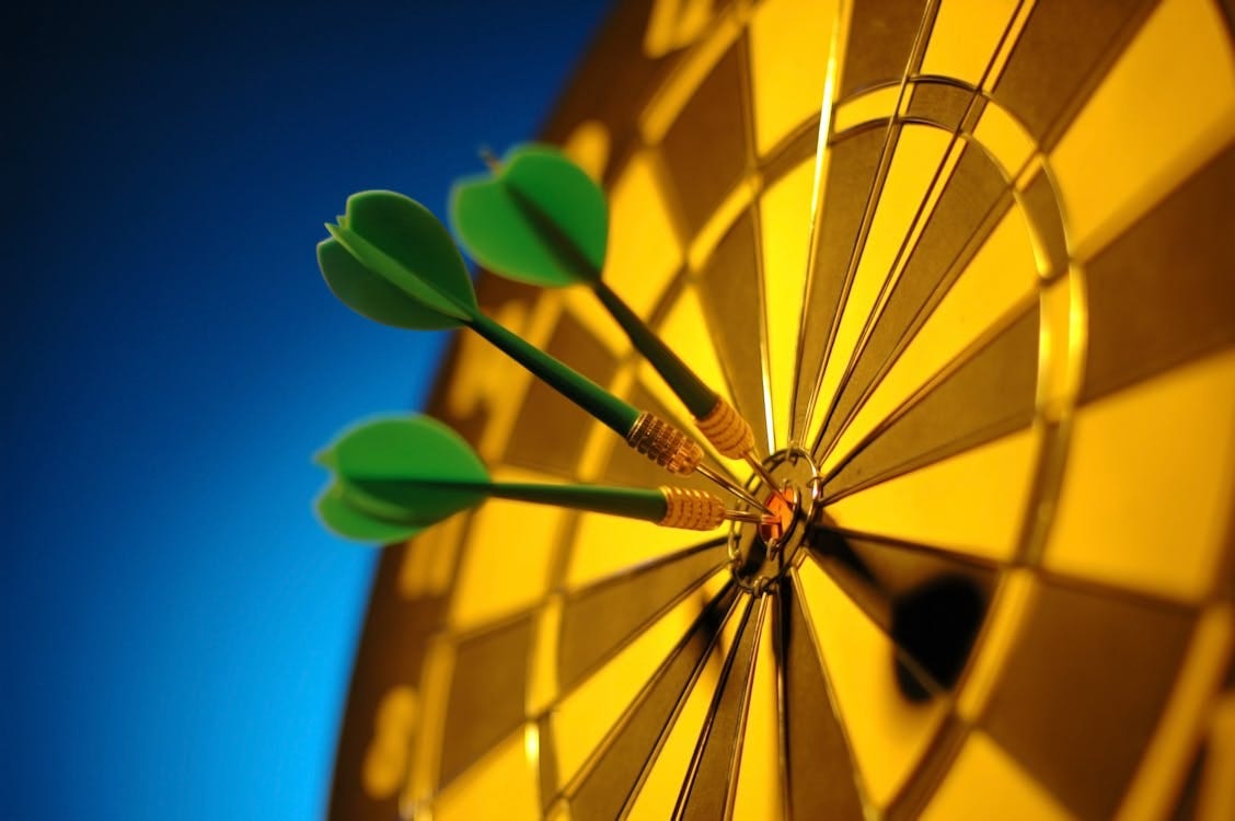 Free Close-up of darts hitting the bullseye on a dartboard symbolizing precision and success. Stock Photo Free Close-up of darts hitting the bullseye on a dartboard symbolizing precision and success. Stock Photo