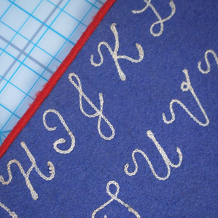 chainstitch alphabet on blue felt