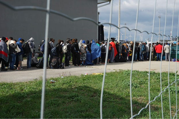 A group of people standing in a line

Description automatically generated