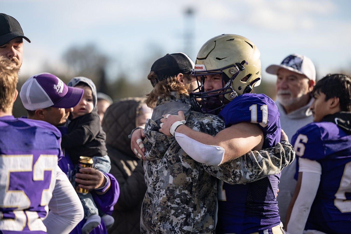 Onalaska’s Blaze Underhill gets emotional while hugging friends after losing the 2B State Quarterfinals against Freeman at Centralia Tiger Stadium Saturday, Nov. 23.