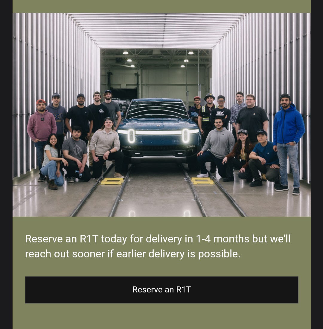 Rivian team standing around an R1T electric truck in a lit garage with reservation call-to-action below