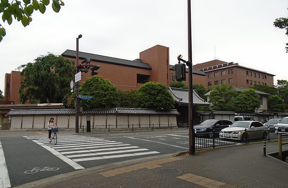 A crosswalk with cars parked in front of a building

AI-generated content may be incorrect.