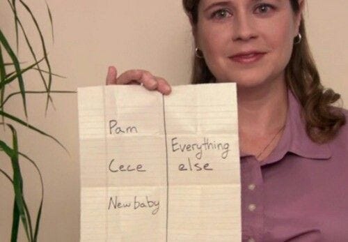 This may contain: a woman holding up two pieces of paper with writing on it that read pam, cee, and new baby This may contain: a woman holding up two pieces of paper with writing on it that read pam, cee, and new baby