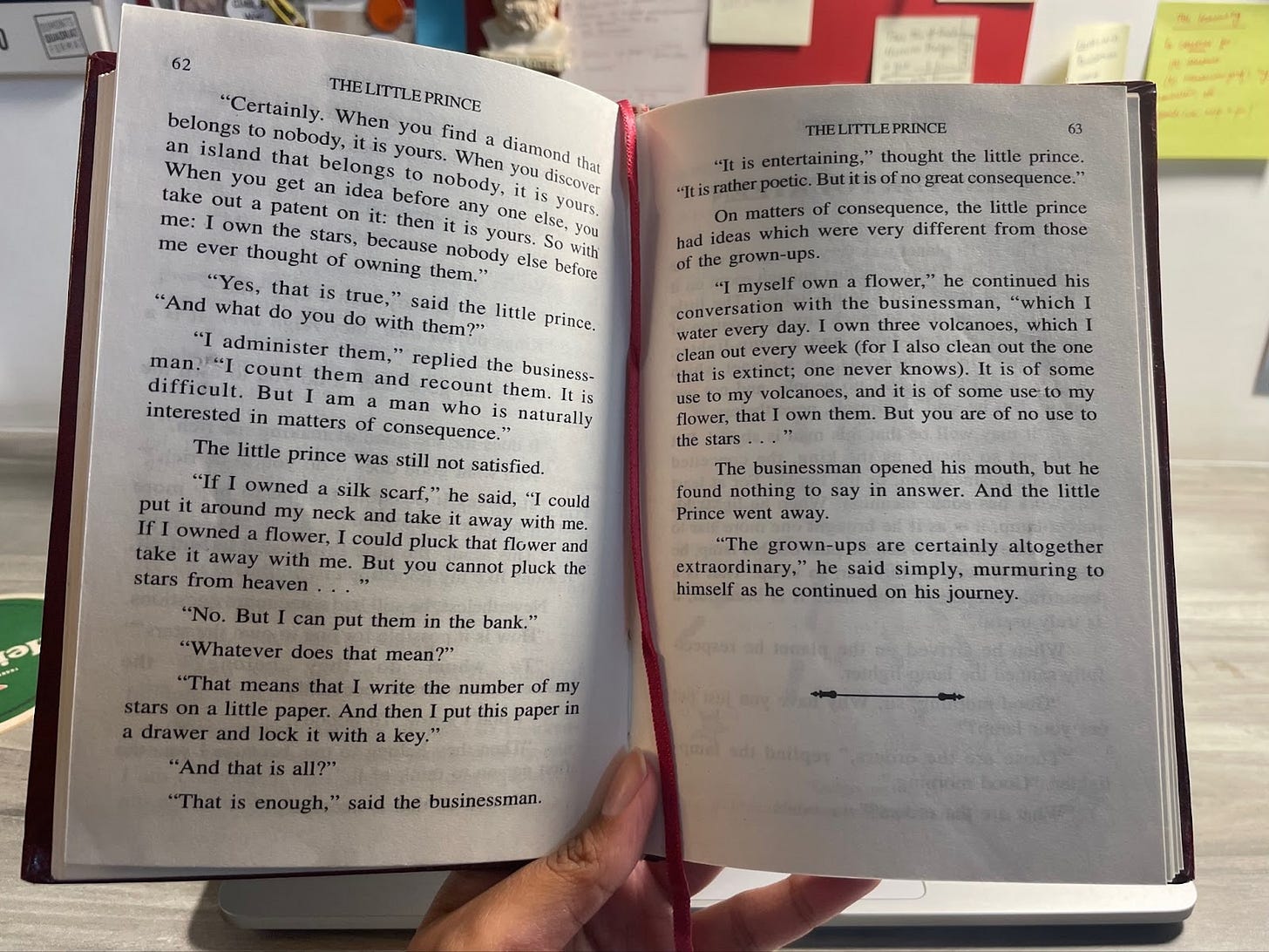 Medhavi holding a book in her hand; one page is opened.