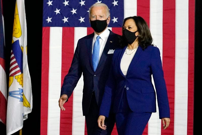 Democratic presidential candidate former Vice President Joe Biden and his running mate Sen. Kamala Harris, D-Calif., arrive to speak at a news conference at Alexis Dupont High School in Wilmington, Del., Wednesday, Aug. 12, 2020. (AP Photo/Carolyn Kaster)
