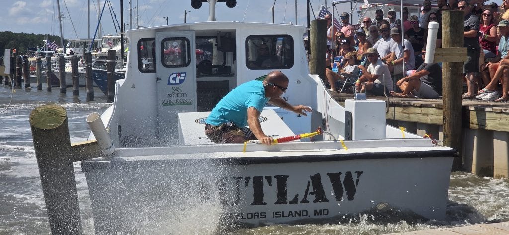 Jake Jacobs prepares to throw a line from Outlaw during the boat-docking contest.