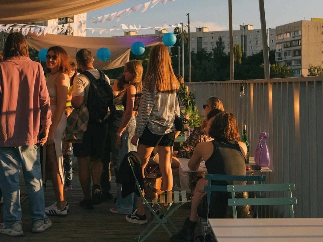 a group of people standing on top of a wooden deck