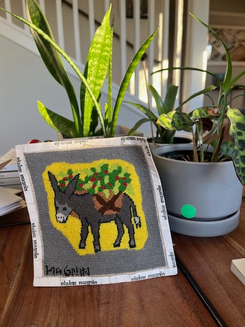 picture of a needlepoint donkey and then one of the donkey in a pillow.