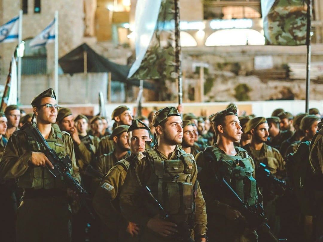 group of armed men with white flag