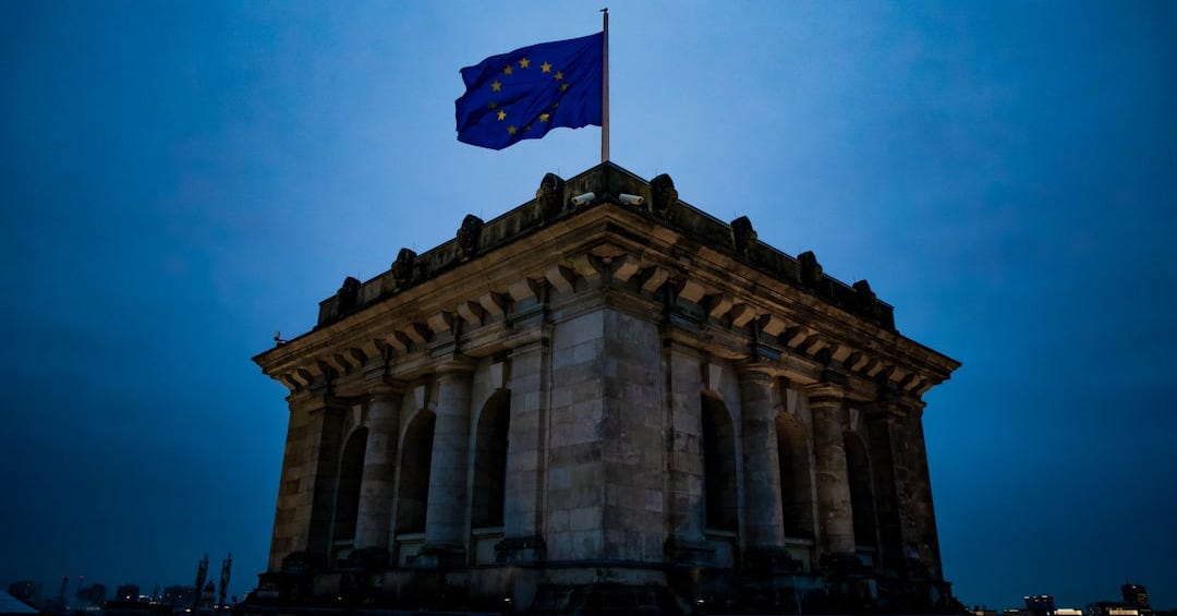 blue and white star flag on top of brown concrete building