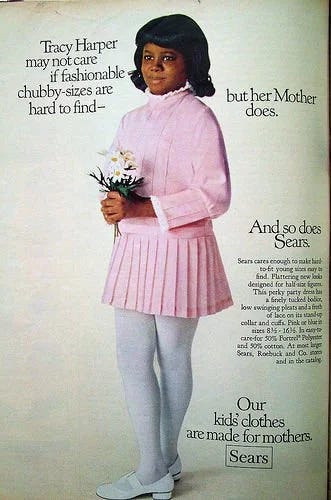 1970s Sears ad for "chubby" girls clothes featuring young Black girl in a pink dress with long sleeves and pleated mini skirt, white tights, and white mary janes shoes. 1970s Sears ad for "chubby" girls clothes featuring young Black girl in a pink dress with long sleeves and pleated mini skirt, white tights, and white mary janes shoes.