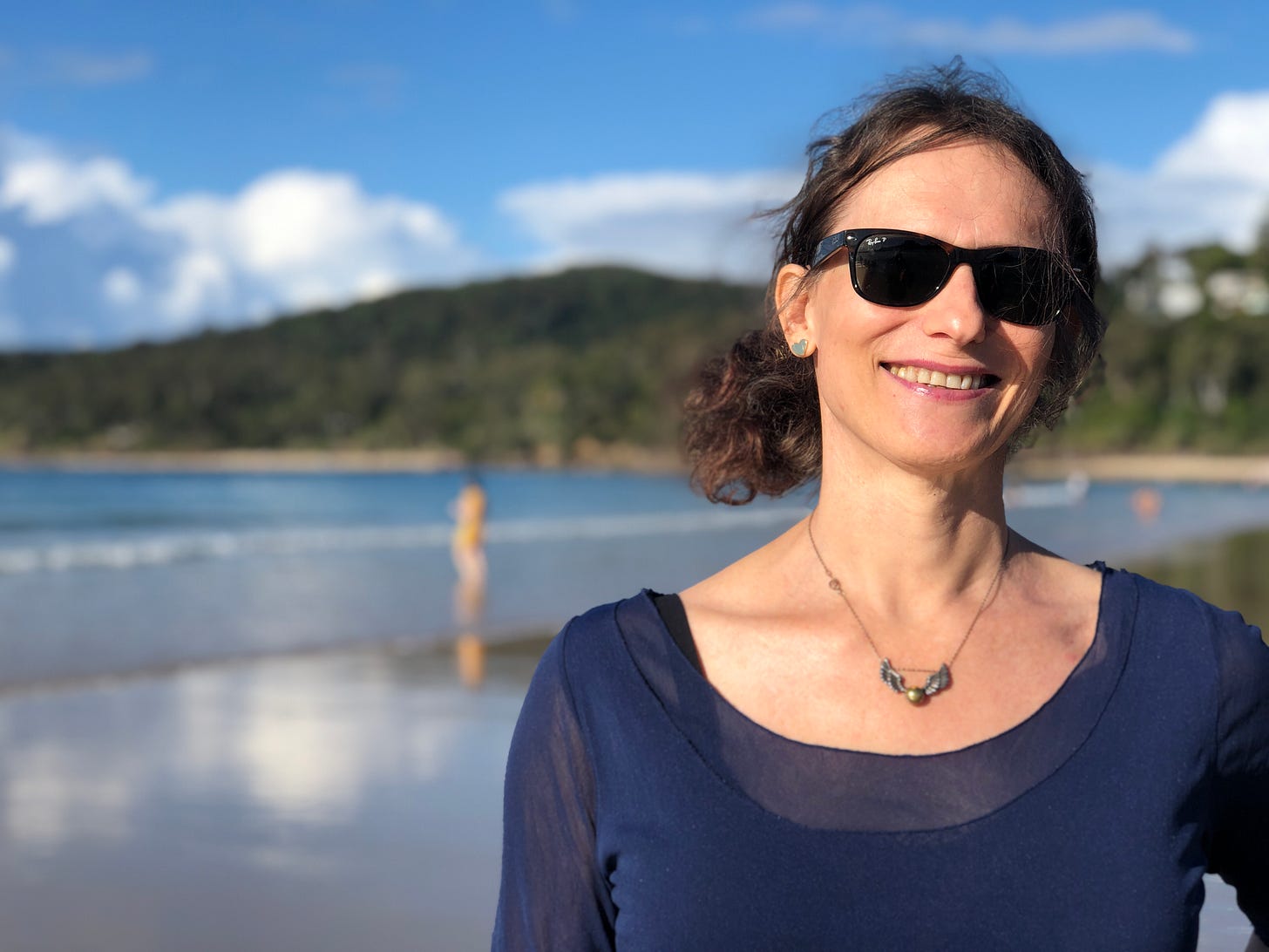 Sarah on the beach, blue skies.