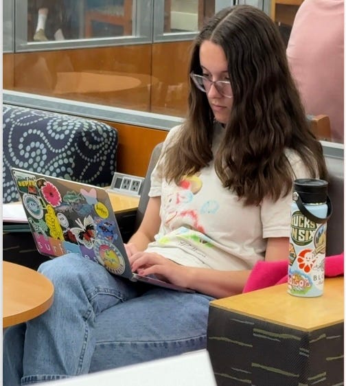 A person sitting on a chair using a computer
AI-generated content may be incorrect.