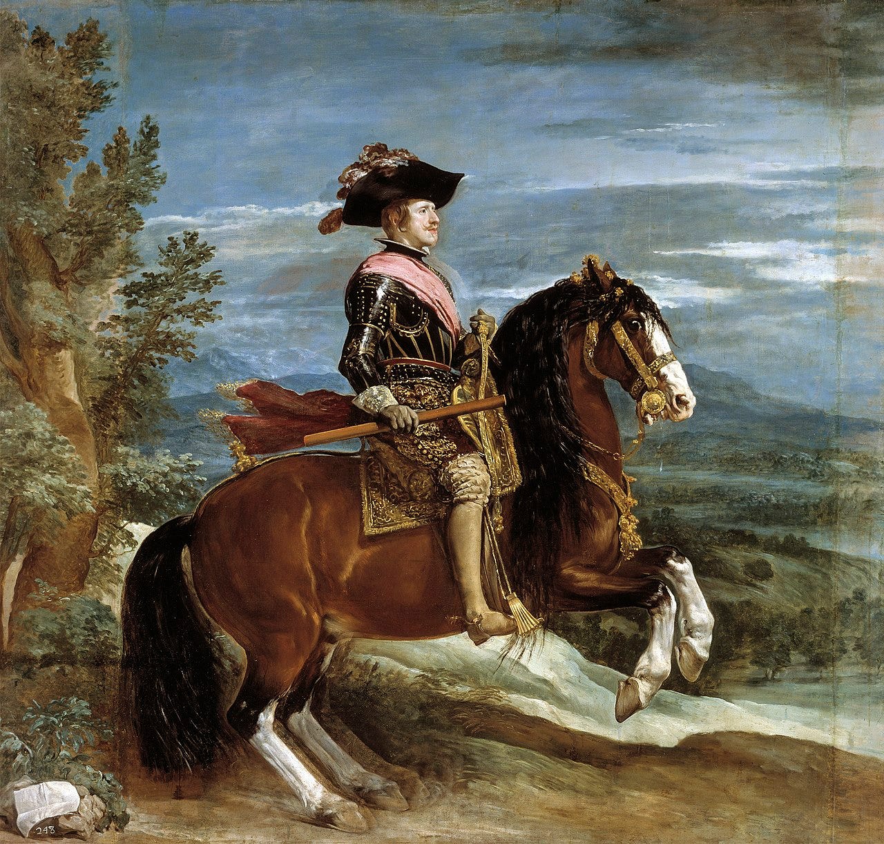 The king of Spain sits calmly on a rearing horse in a wide landscape The king of Spain sits calmly on a rearing horse in a wide landscape