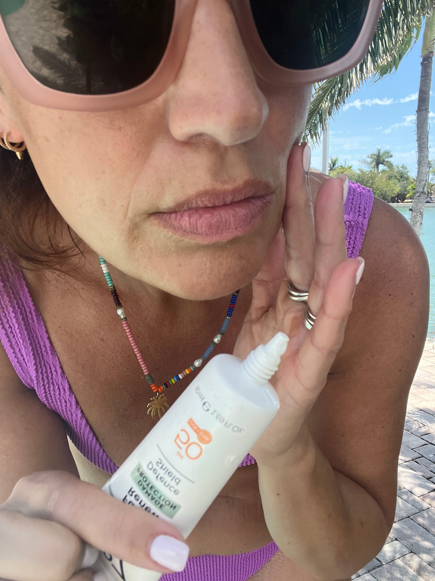 Close-up shot of Beauty Editor Donna Francis demonstrating the lightweight, invisible texture of daily facial sunscreen on her skin.
