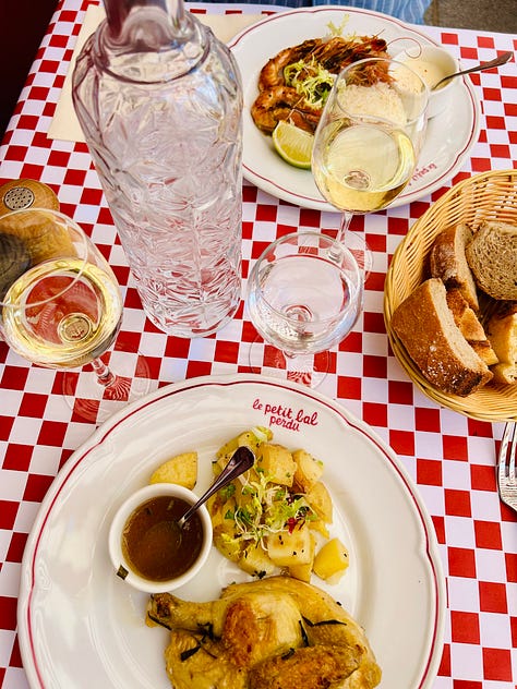 Different scenes from summer in France. A green garden with bench; a river with a table set for lunch in the water; a father and his kids; a classic red and white checked French tablecloth: Karen Bussen at home in her gardening apron; lunch plates from the Moulin de Flagy; and scenes of sunset and flowers in France