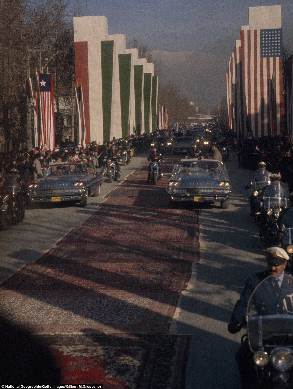 Rolling out the red carpet: Persian rugs line the road for President Eisenhower's motorcade in Tehran in 1960