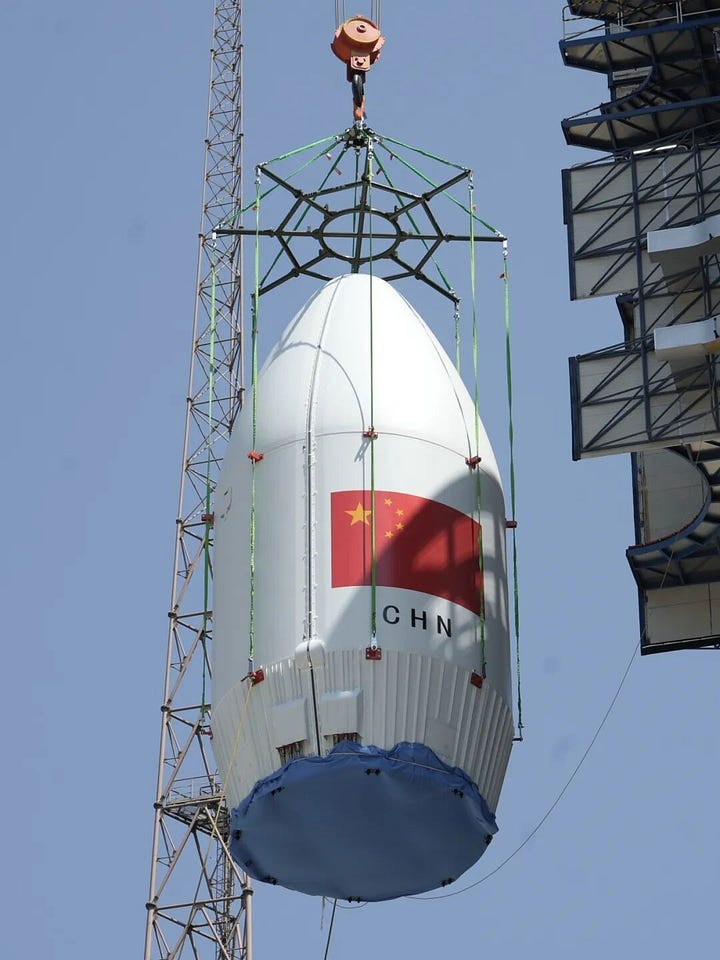 The Long March 2D's first-stage and fairing being handled at Launch Complex 3 ahead of flight.