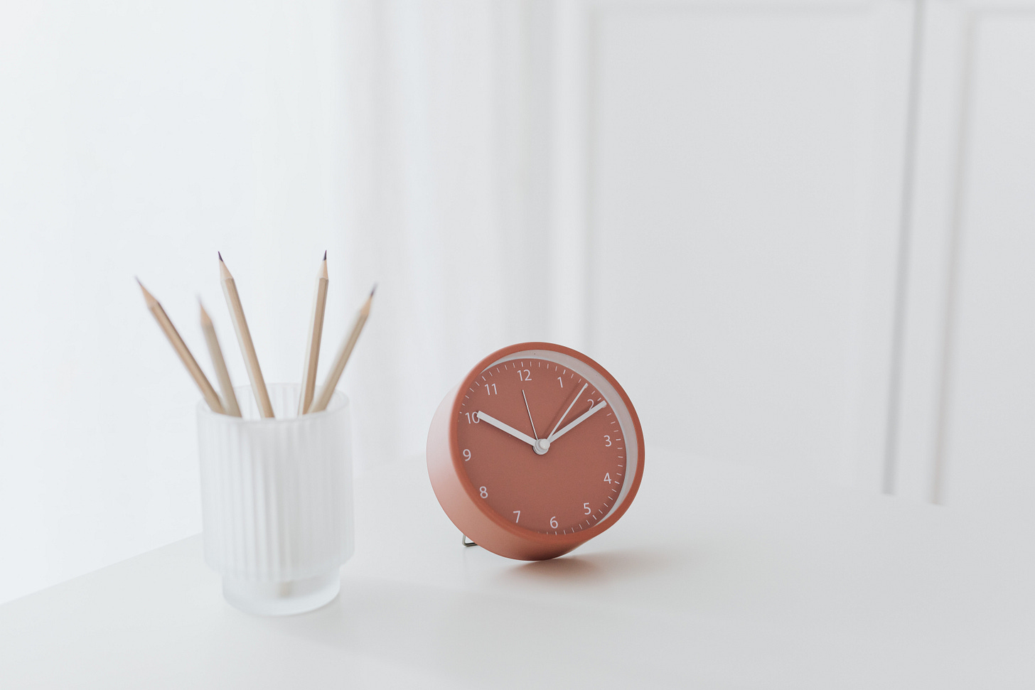 photo of desktop clock and pencils photo of desktop clock and pencils
