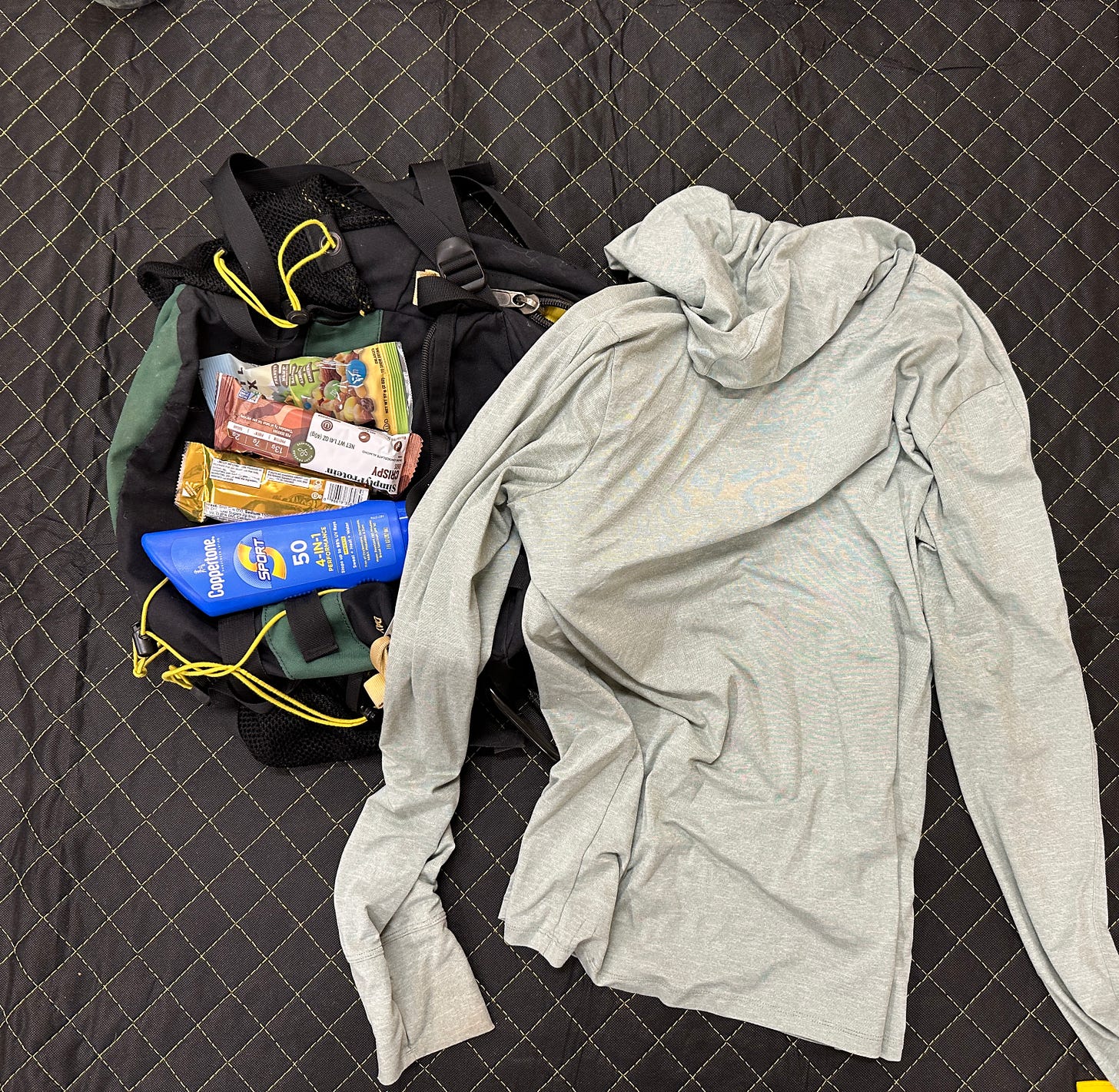 A utility bag's contents laid out on a blanket. A utility bag's contents laid out on a blanket.