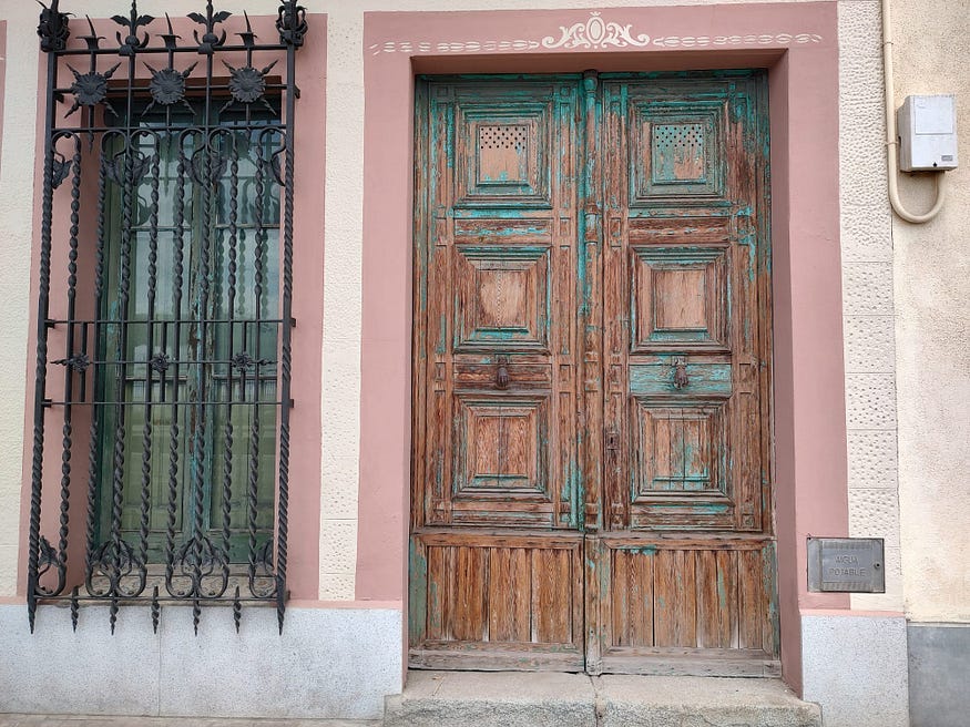an old door in Barcelona. The old architecture is absolutely beautiful, and replicated in the Mexican city of Merida almost exactly.