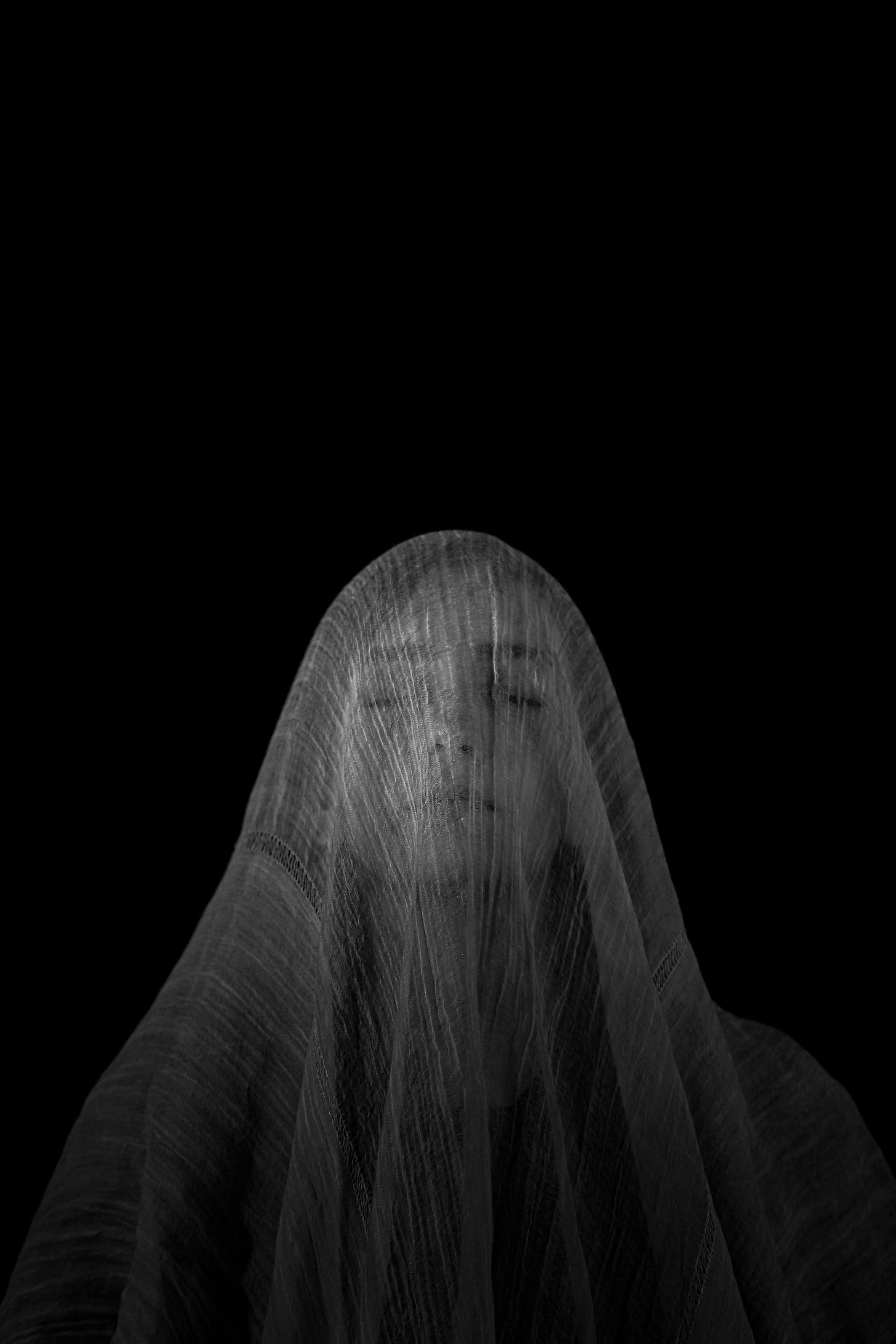 image of a woman with a white veil covering her face. image of a woman with a white veil covering her face.