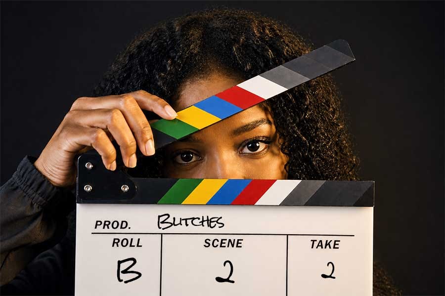 Black woman holding film clapper