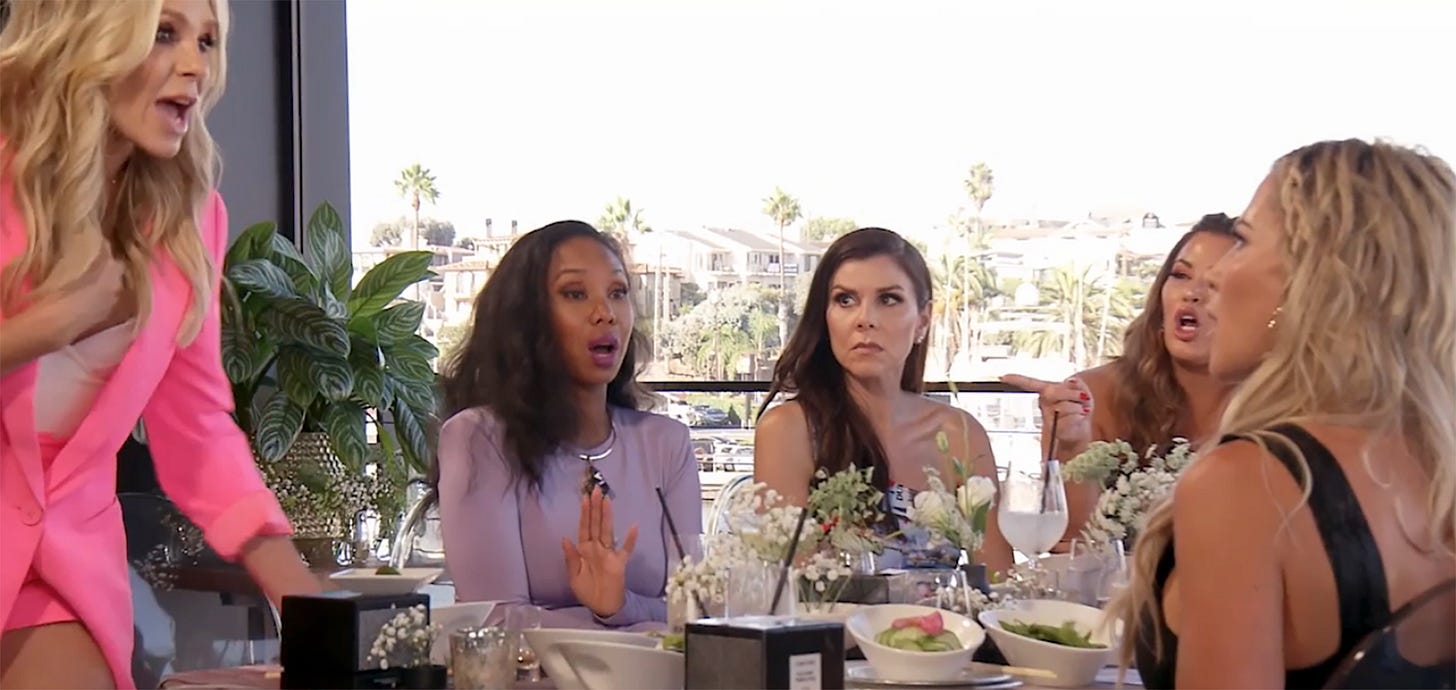 The "RHOC" cast sitting for dinner