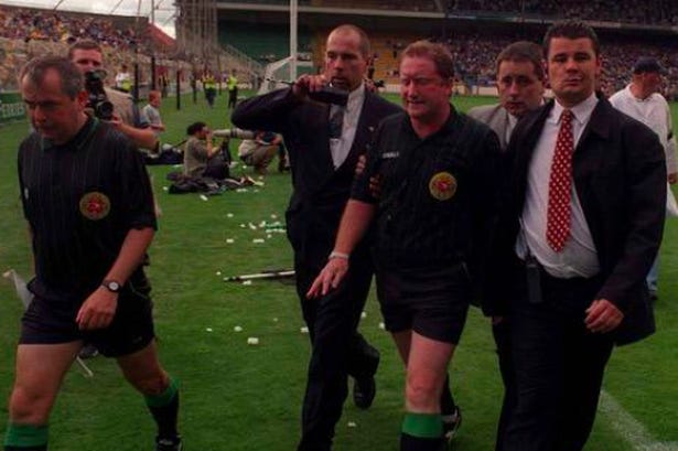Jimmy Cooney being escorted off the field during the Offaly versus Clare 1998 All-Ireland semi-final replay Jimmy Cooney being escorted off the field during the Offaly versus Clare 1998 All-Ireland semi-final replay