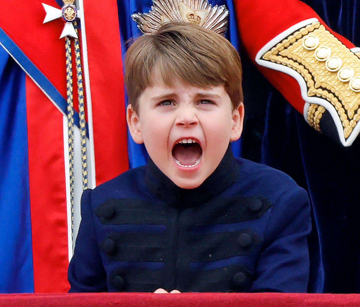 Prince Louis grinning on palace balcony