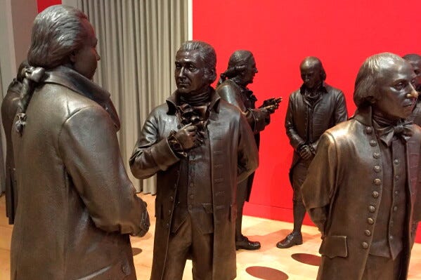 Life-size bronze sculptures of the signers of the U.S. Constitution stand in the Signers' Hall on July 7, 2016, at the National Constitution Center in Philadelphia. (AP Photo/Beth J. Harpaz, File)