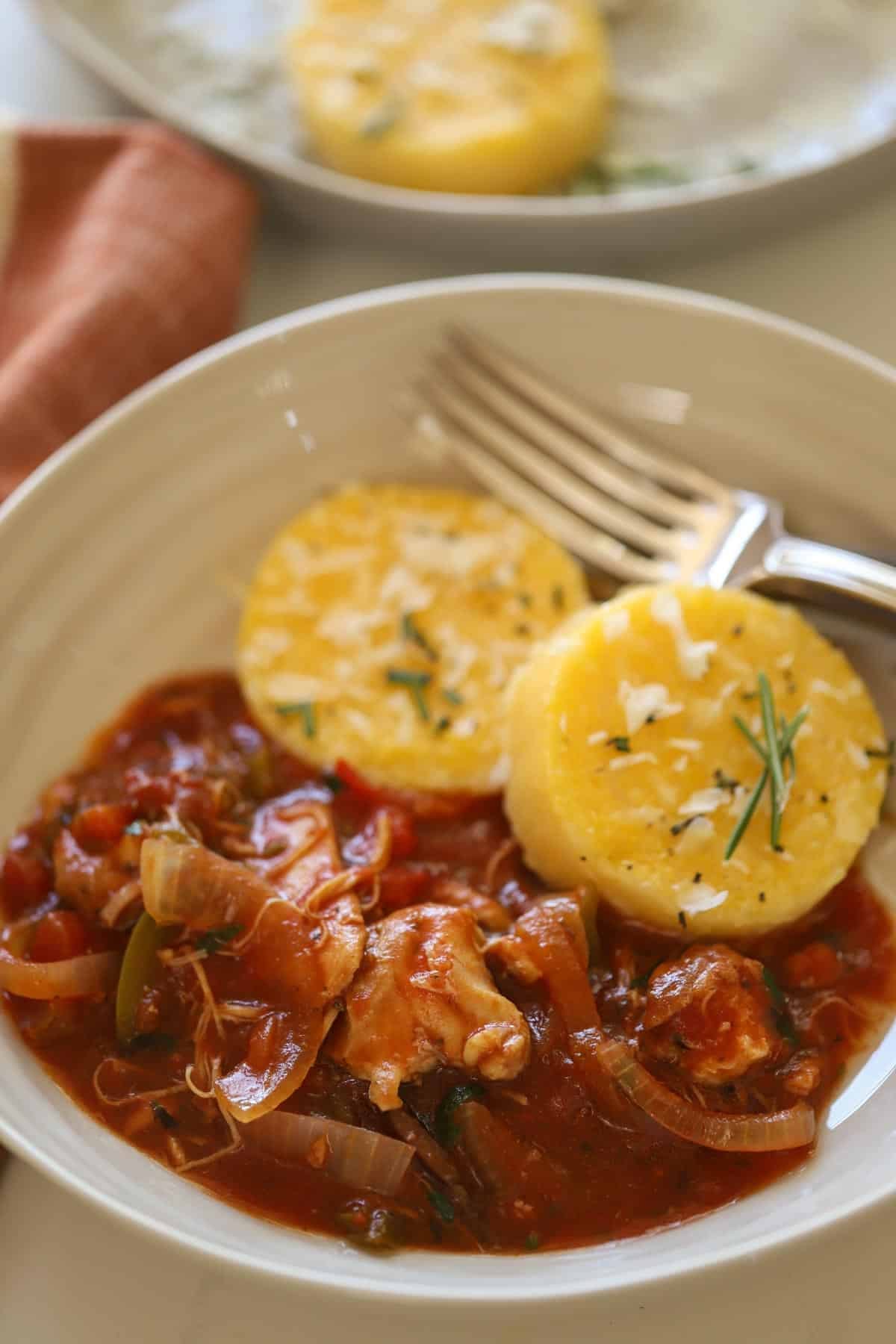 a bowl of slow cooker chicken cacciatore with polenta cakes a bowl of slow cooker chicken cacciatore with polenta cakes