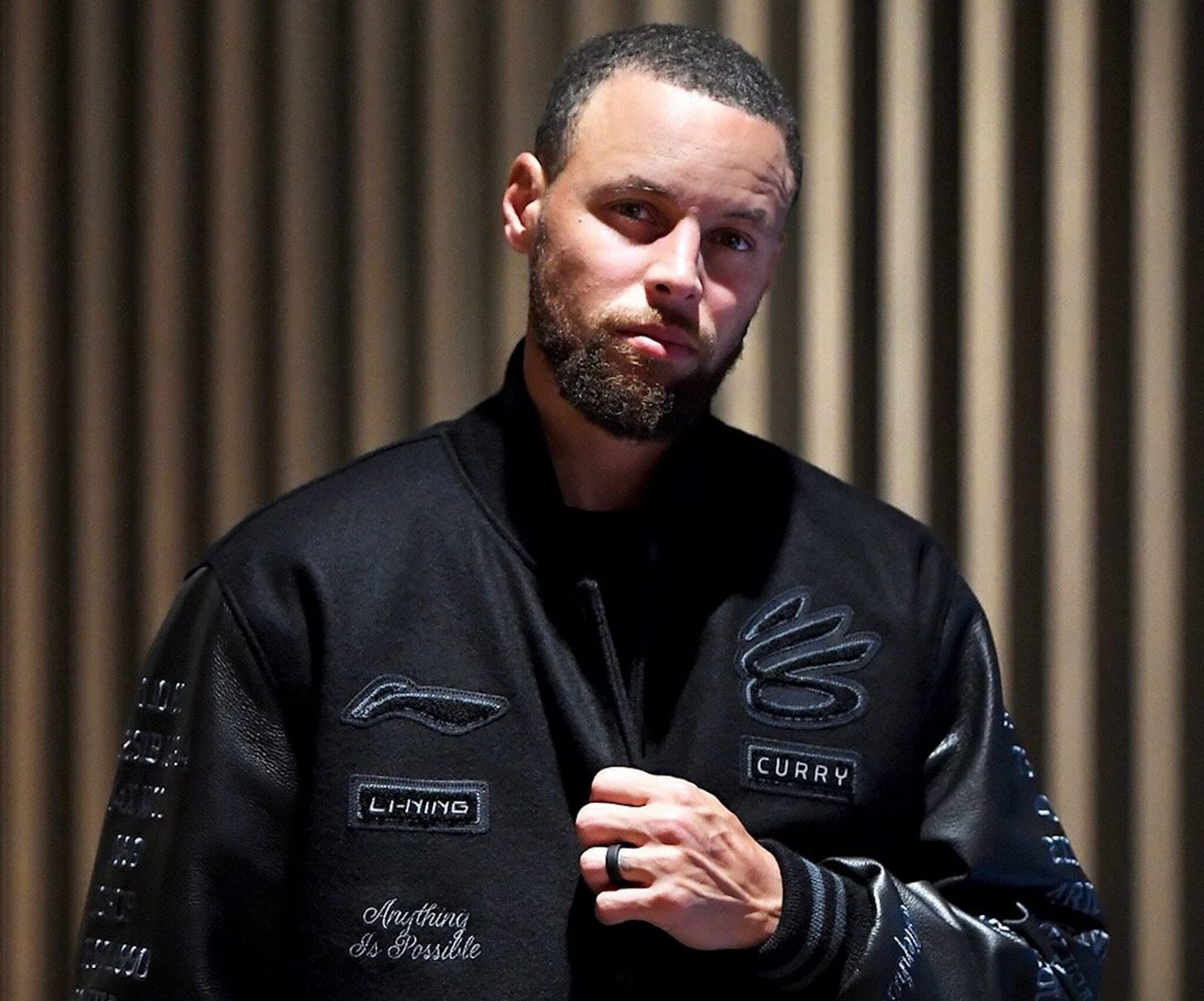 Stephen Curry in his Li-Ning x Curry Brand varsity jacket to announce his new partnership. Stephen Curry in his Li-Ning x Curry Brand varsity jacket to announce his new partnership.