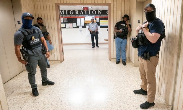 Federal law enforcement officers are pictured in the Jacob K. Javits Federal Building in Manhattan on Thursday. 