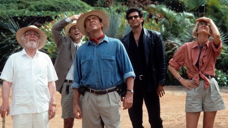 This may contain: four men are standing in the dirt with their hats on and one has his eyes closed