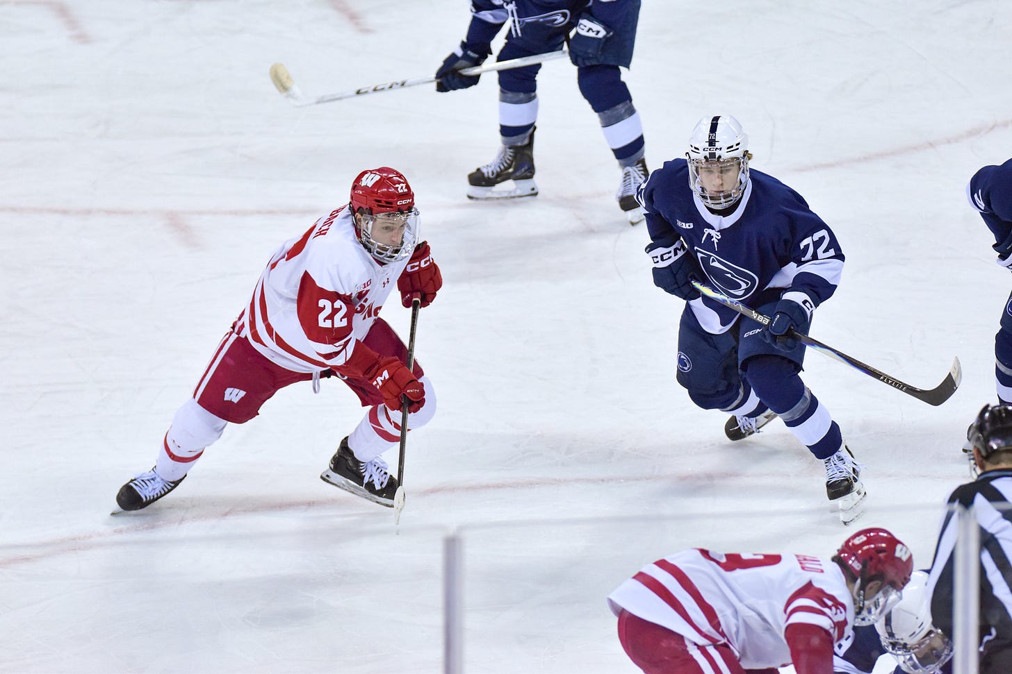 Jack Horbach prepares for a faceoff in the Wisconsin offensive zone from the right faceoff circle. He and McKenna look toward the faceoff dot from the hashmarks in the slot. Jack Horbach prepares for a faceoff in the Wisconsin offensive zone from the right faceoff circle. He and McKenna look toward the faceoff dot from the hashmarks in the slot.