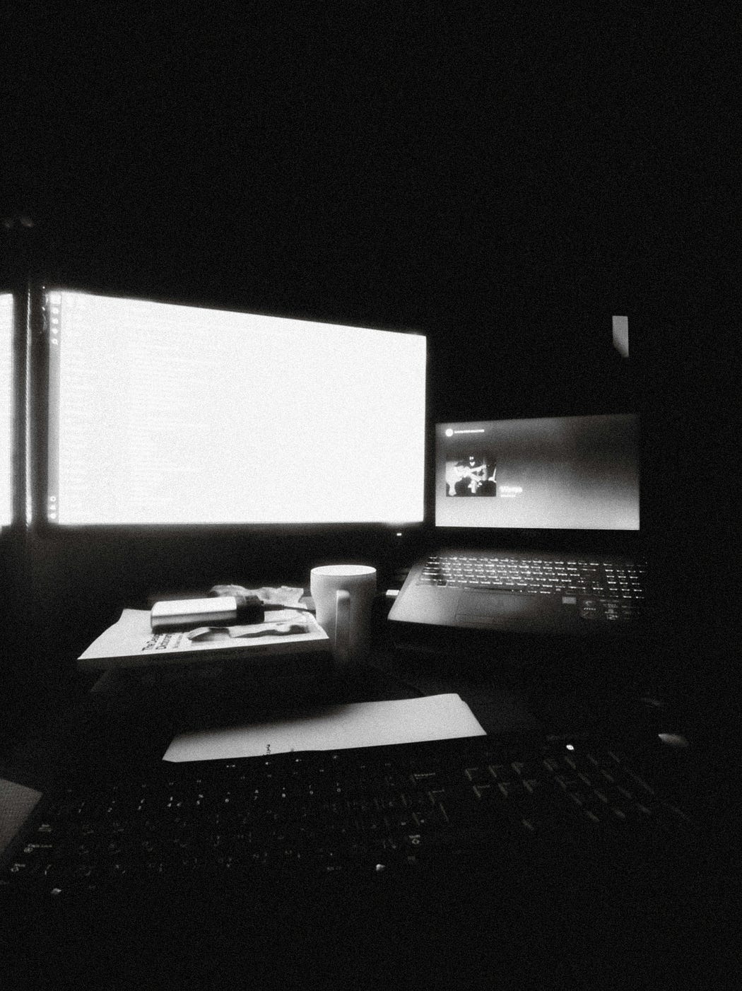 a black and white computer setup in the dark