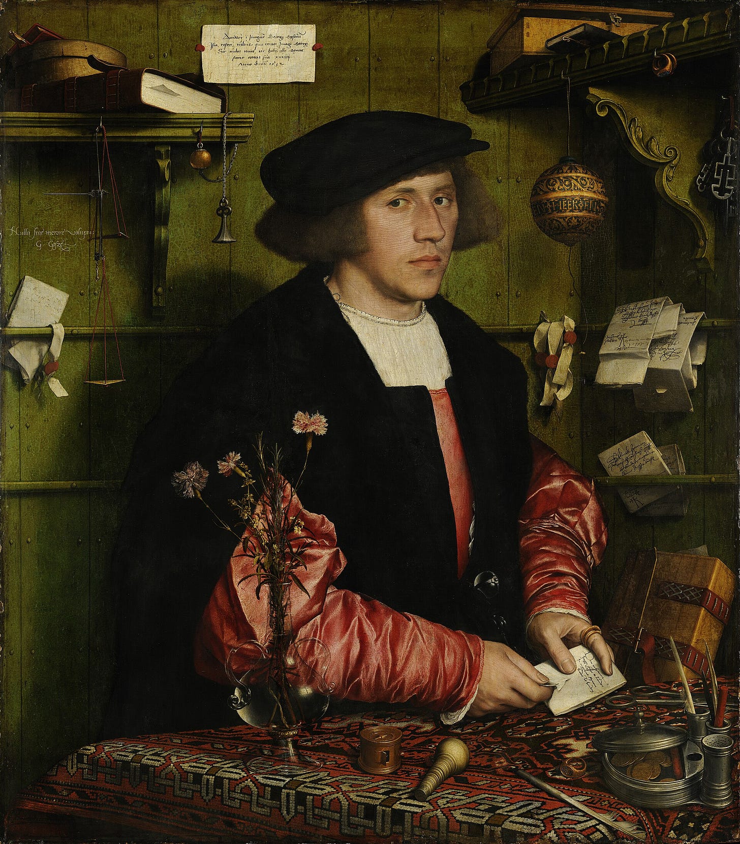Georg Gisze in a black cap and red silk sleeves opens a folded letter at a table with scales, a seal and letters tucked behind wooden strips on a green wall Georg Gisze in a black cap and red silk sleeves opens a folded letter at a table with scales, a seal and letters tucked behind wooden strips on a green wall