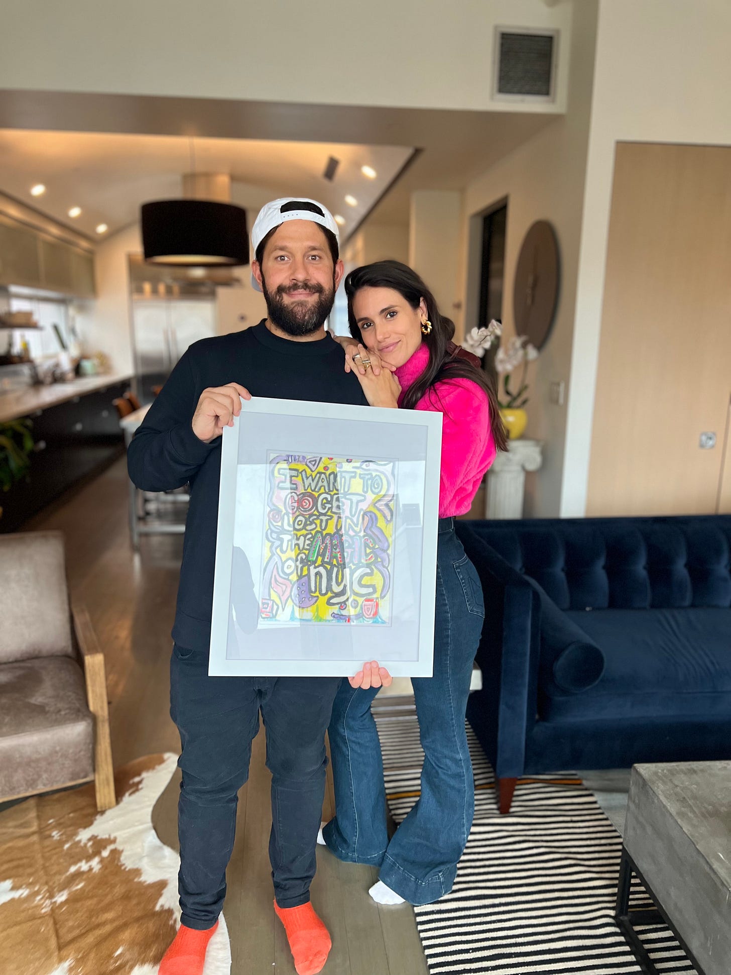 pat and liz holding one of pat's paintings