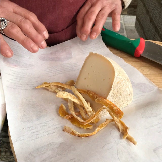 Pictures of cheese, lemons, Buddha's Hand citrus, bottles of chinotto and views of the town.