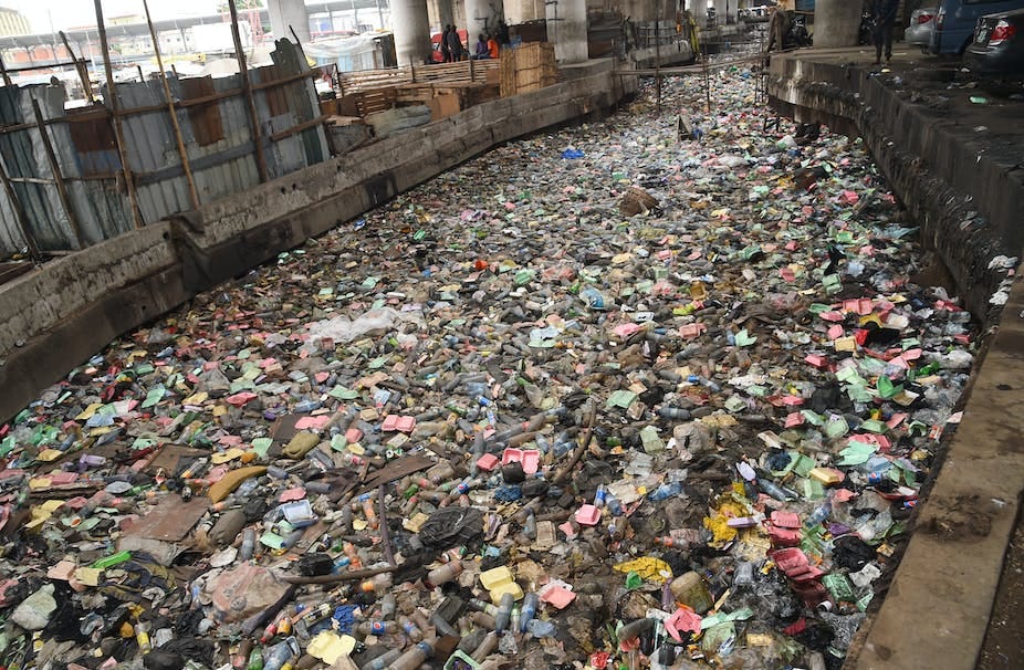 Plastic and other debris in a drainage Plastic and other debris in a drainage