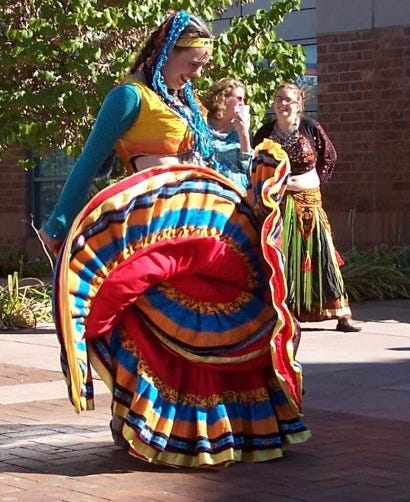 Immense skirts whorl, ripple, and pop in turquoise and yellow, and red with a five-tier hem.