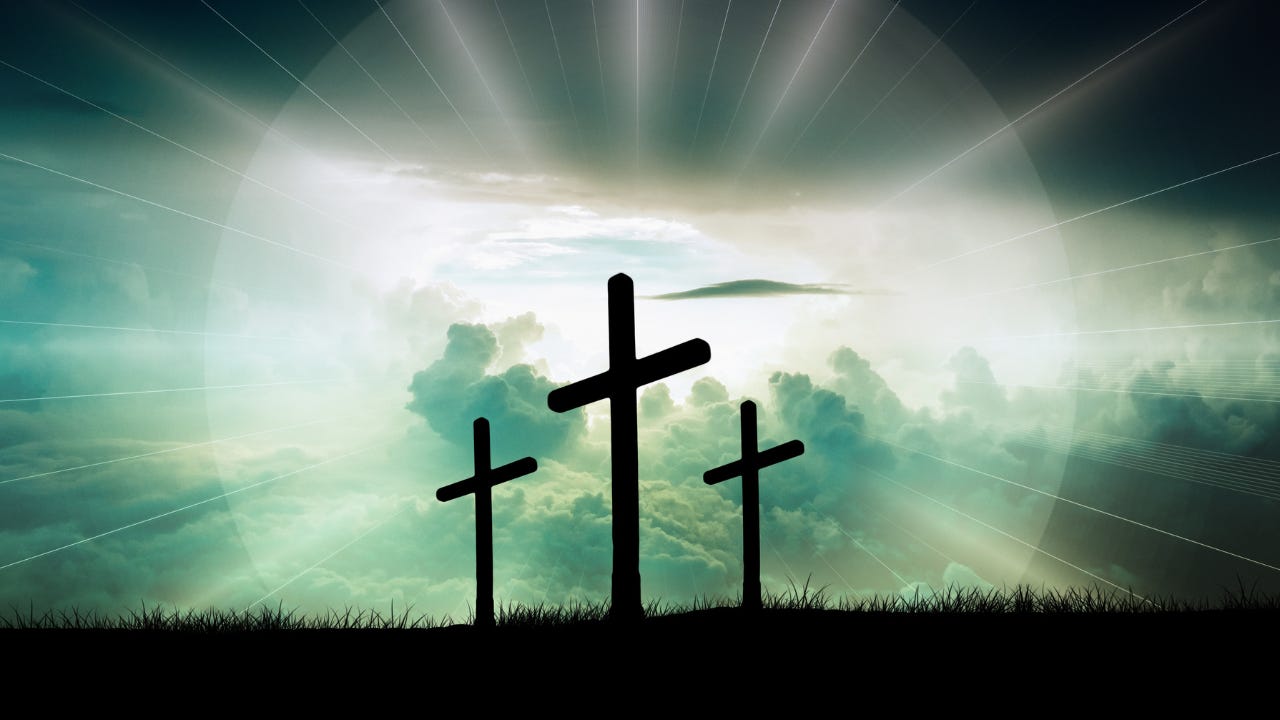 Three crosses in front of the clouds. 