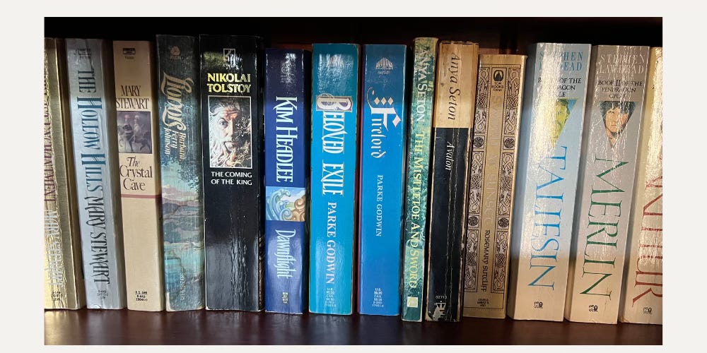 a row of Arthurian fiction books
