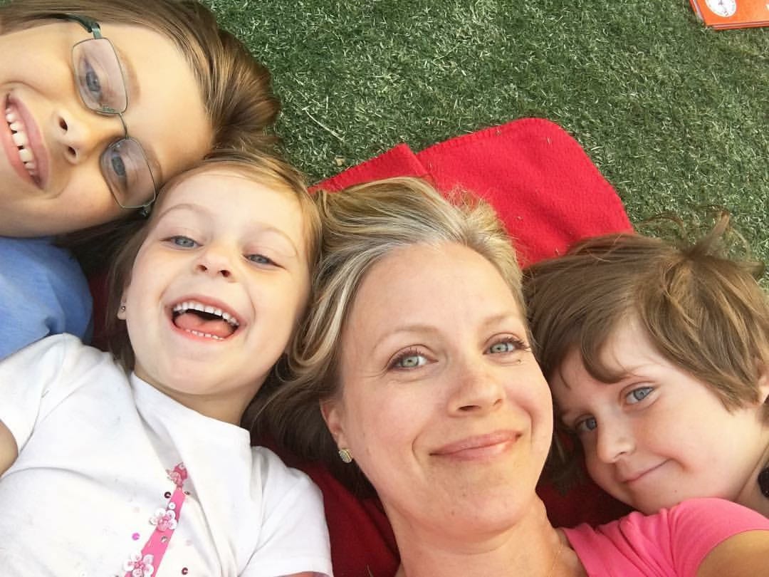 Family lying on grass in a park