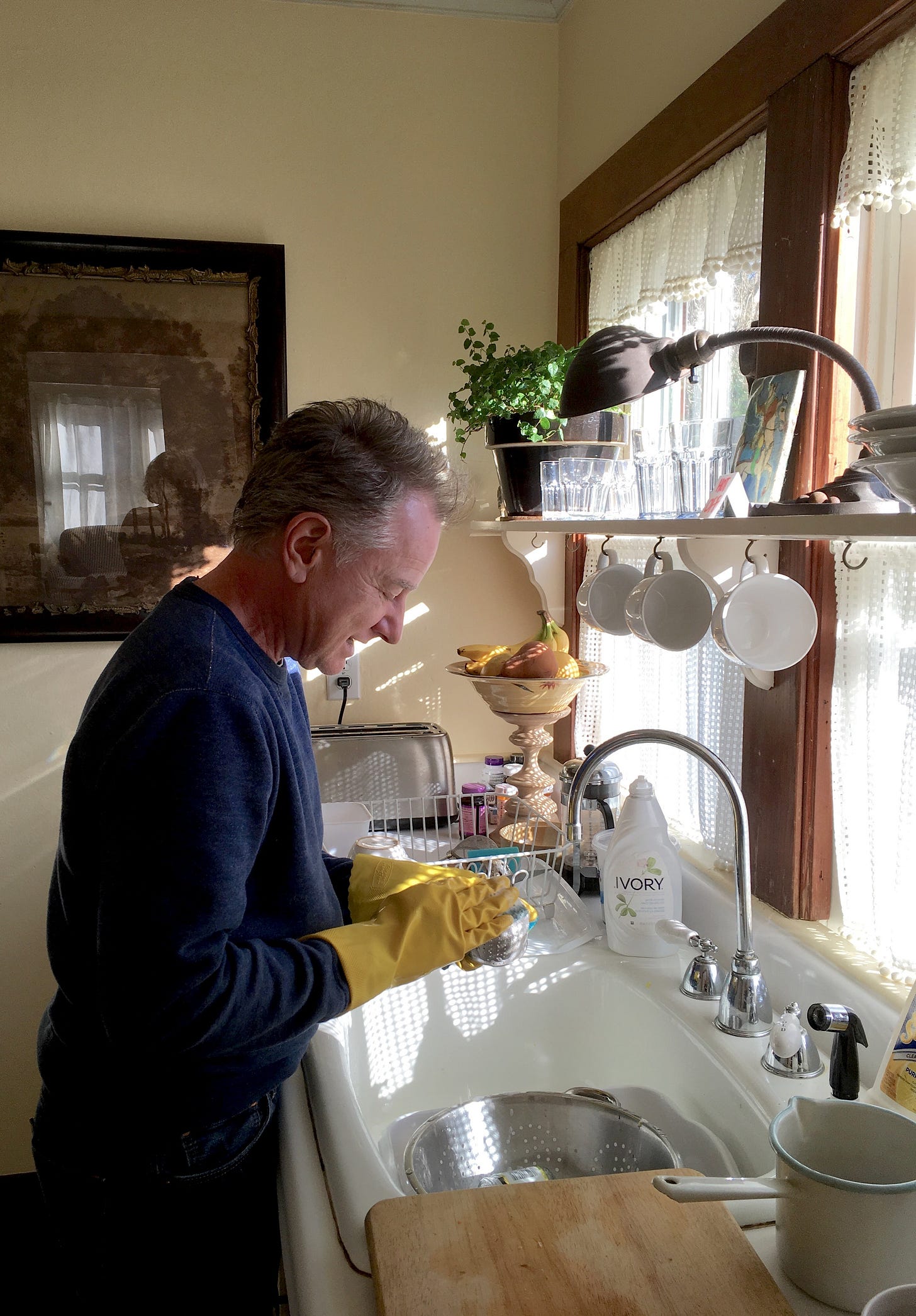 Nicholas Grimshaw washing dishes in the kitchen at Pleasant Lane in East Hampton while in cancer remission.