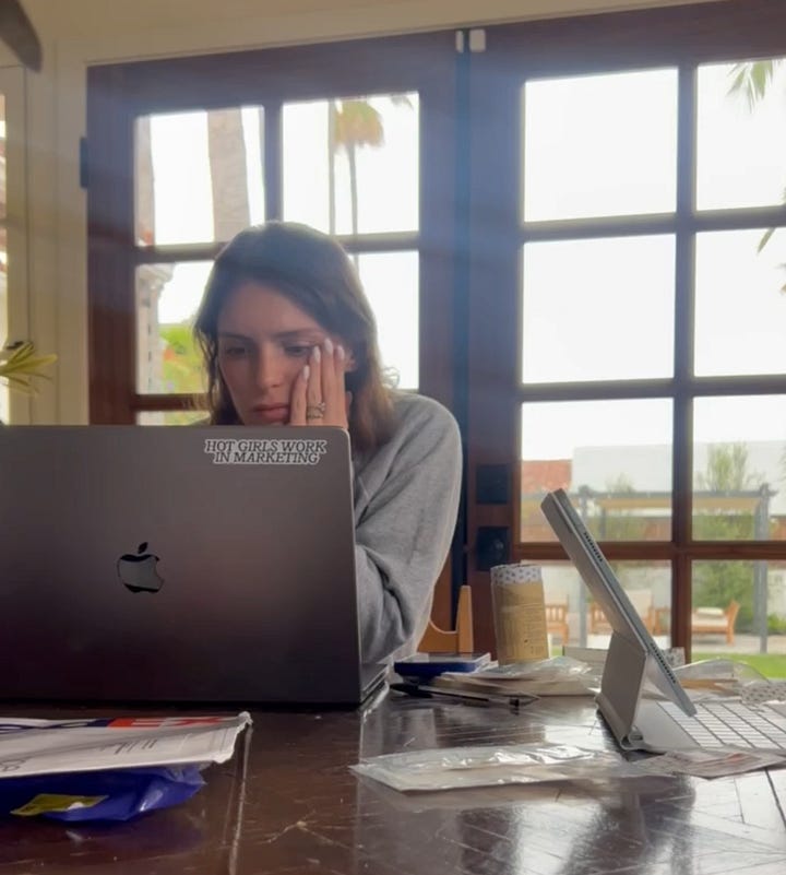 Early Benjie branding concepts the founders decided against, shown beside Tessa Cohen working at a laptop during the product design  process.