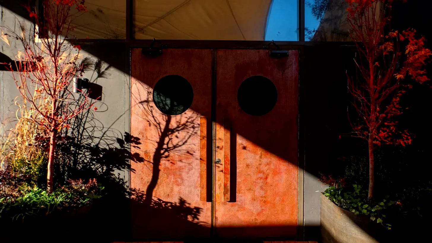 Exterior of Signal nightclub in East Williamsburg Brooklyn at night, featuring warm orange lighting and modern architectural design with garden entrance